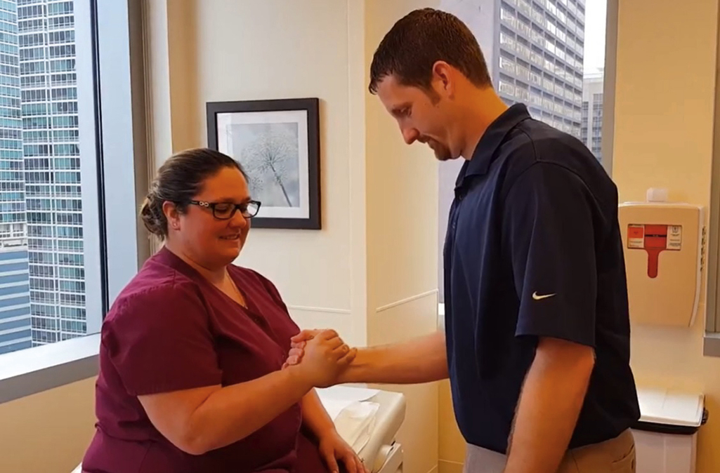 The photograph shows yergason test for biceps tendinopathy: clinician resists a seated patient’s forearm supination while holding the flexed elbow and hand to assess tendon pain or instability.